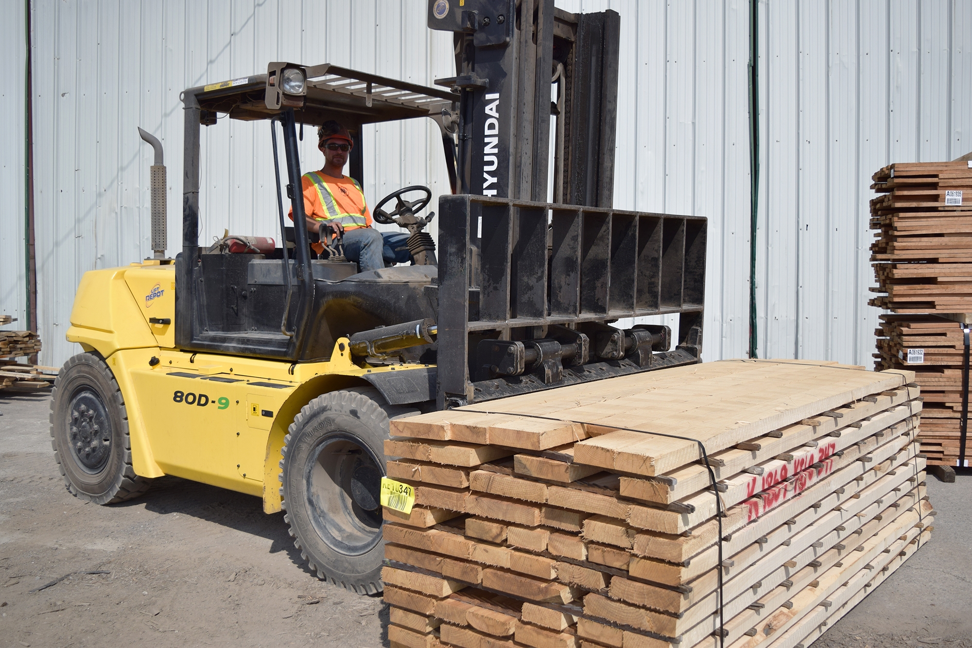 Man in construction uniform driving forklift