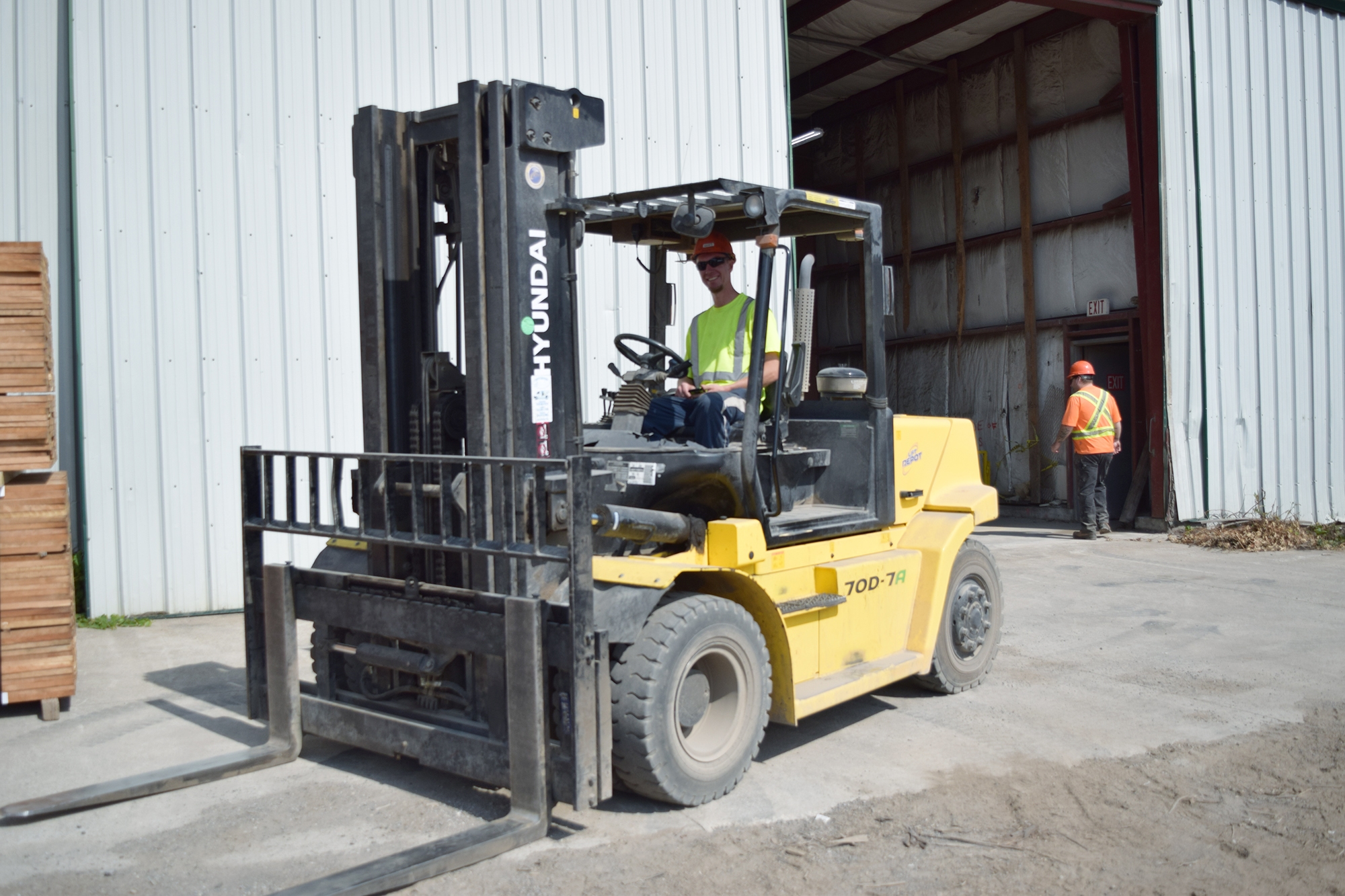 Man in construction uniform driving forklift