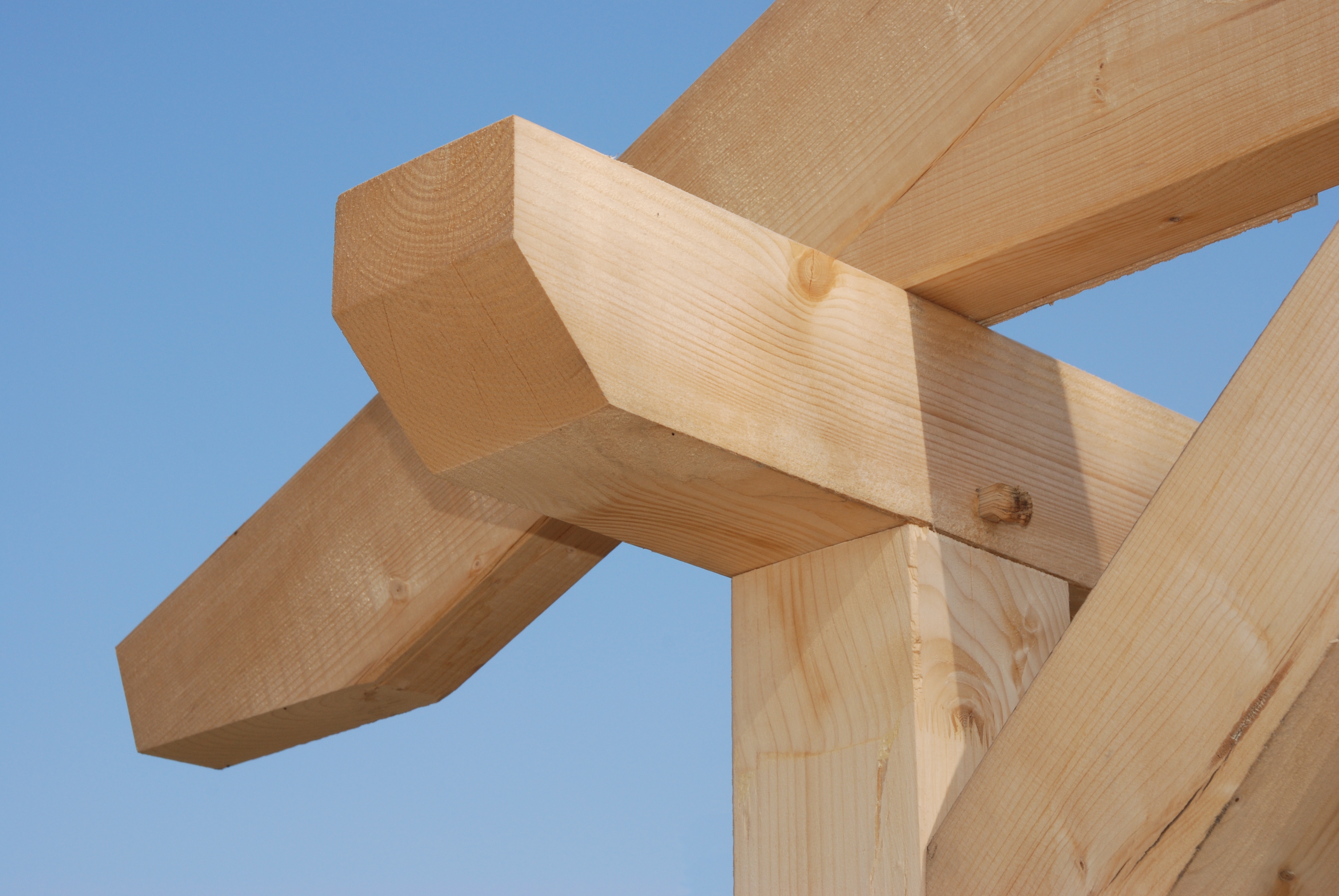 Close up of a timber frame construction for a house.