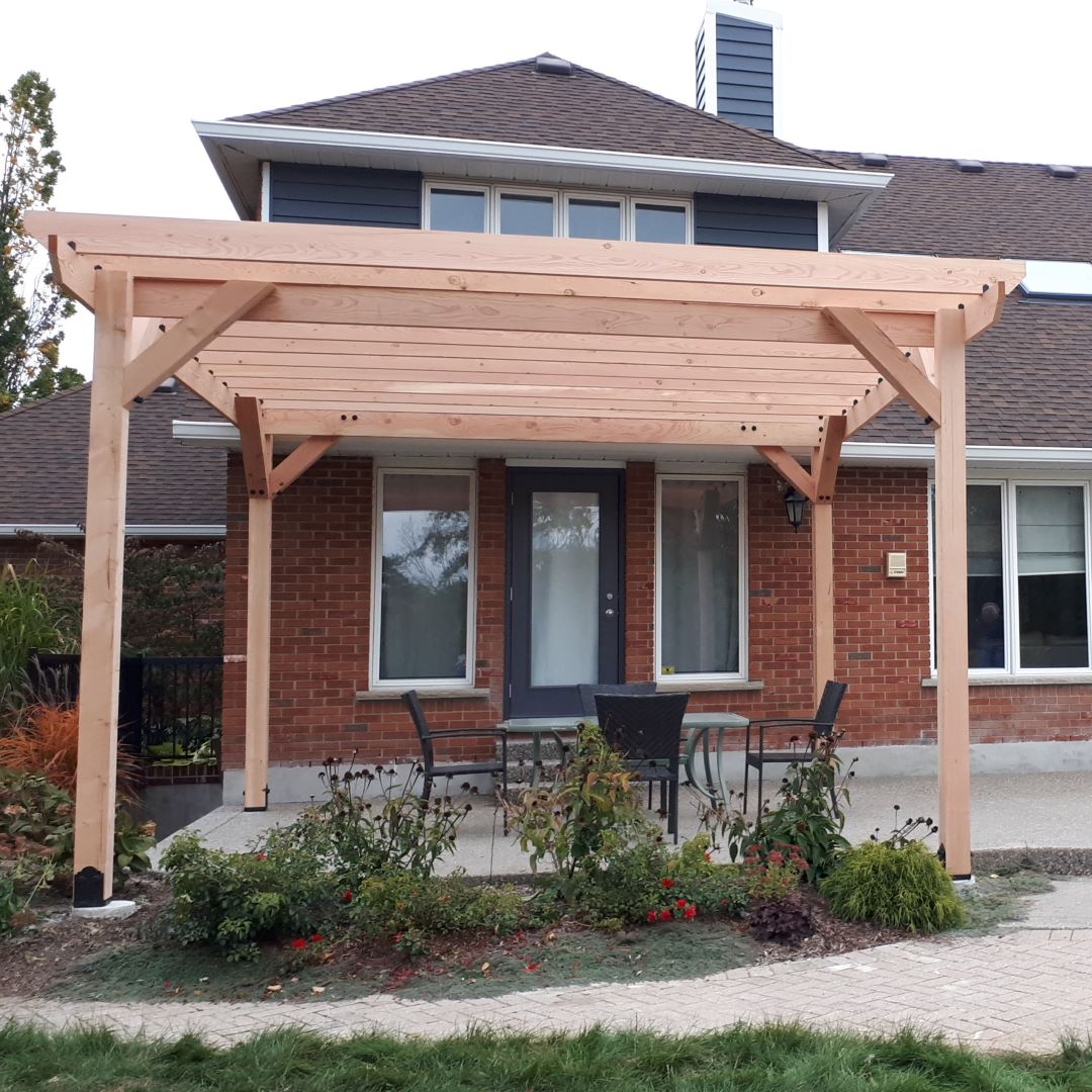 Pergola behind house in backyard